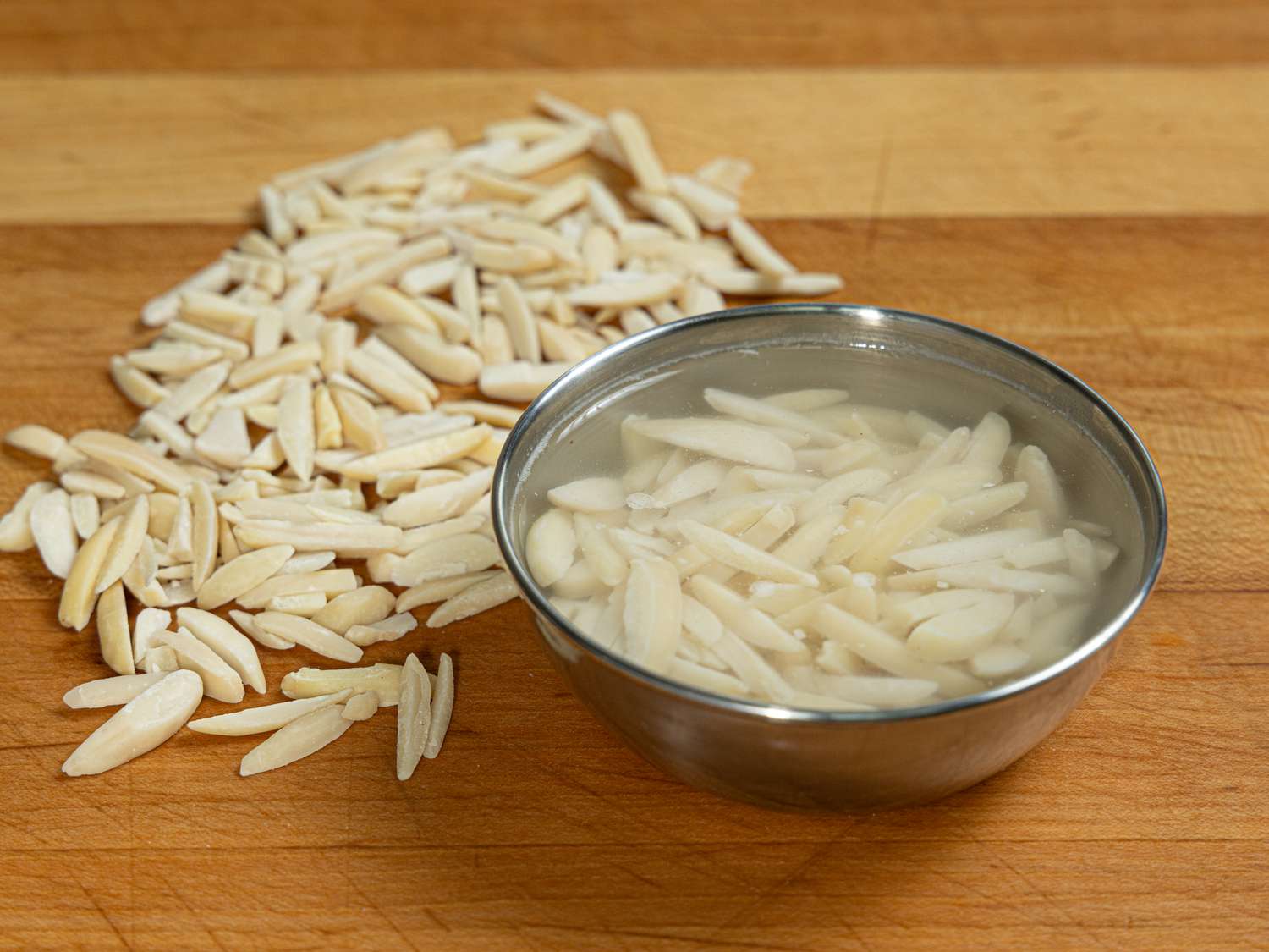 Overhead view of almonds soaking in rosewater