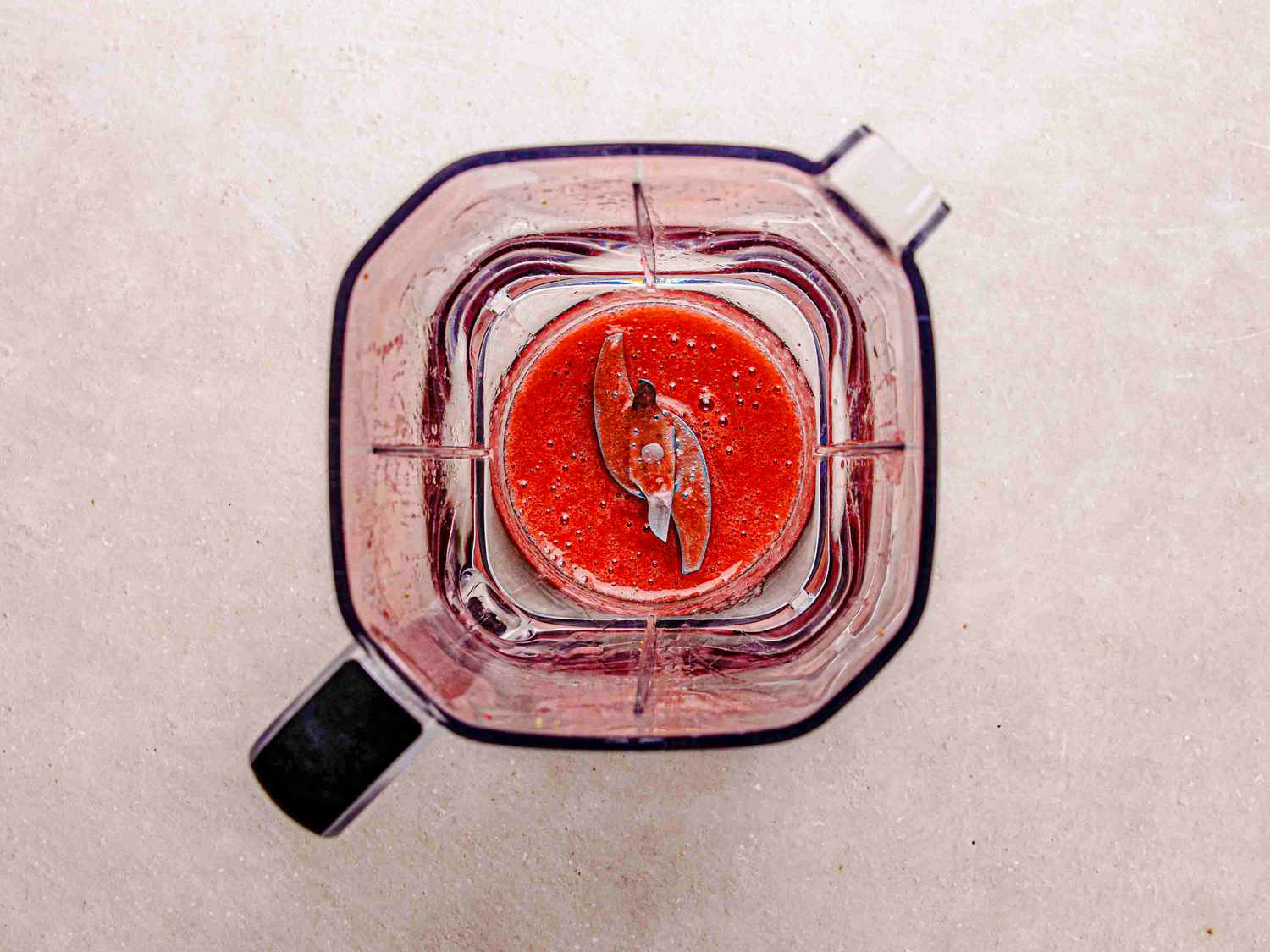 Overhead view of strawberry mixture in blender