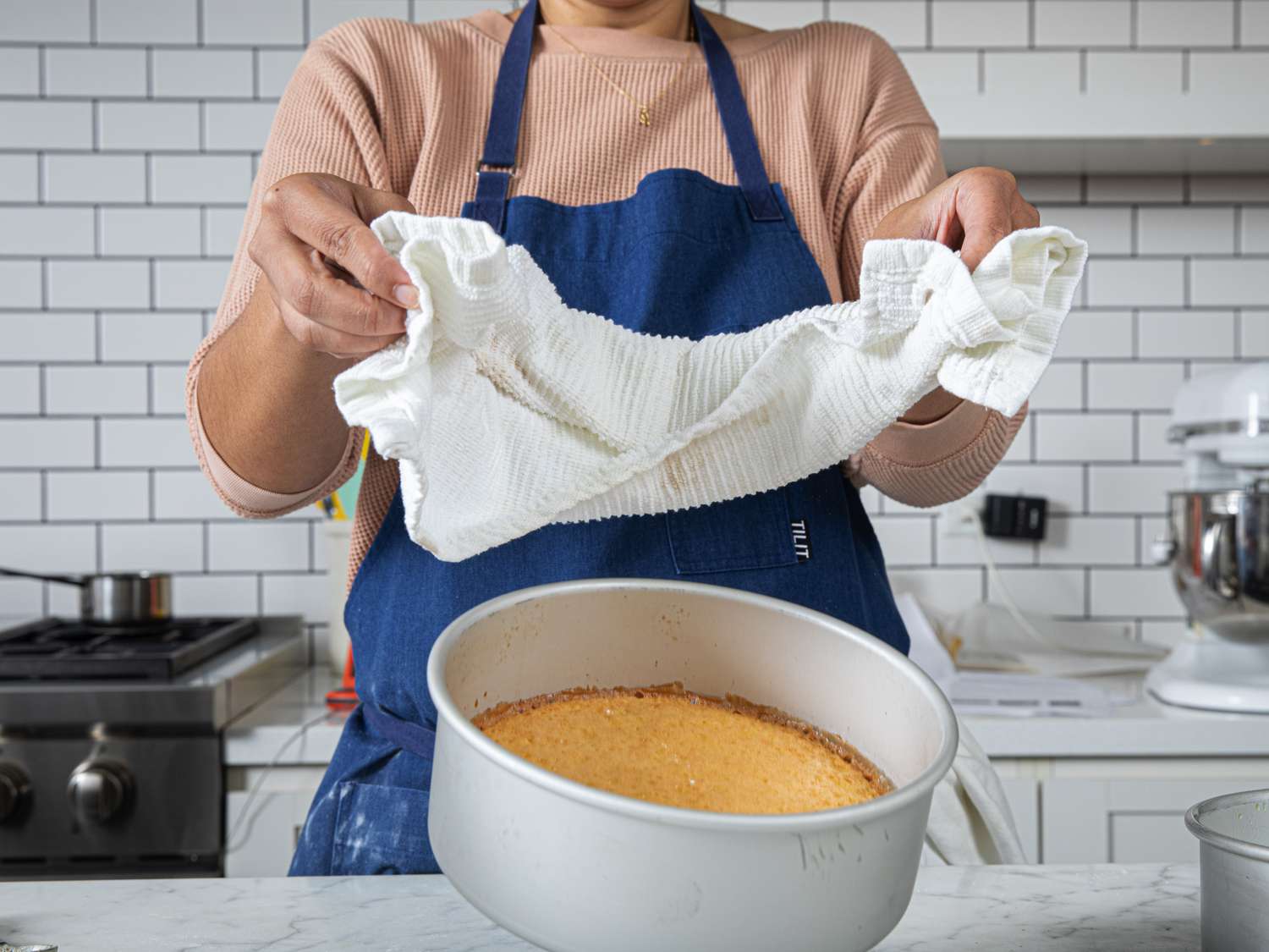 Dropping the cooked cake pan onto counter