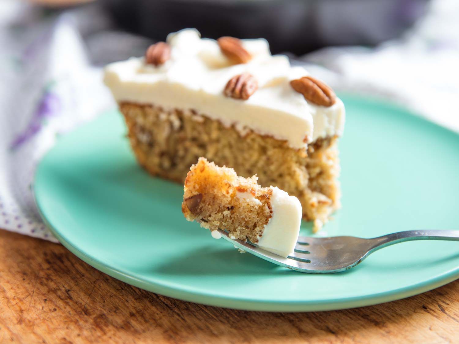 slice of hummingbird cake with forkful in focus