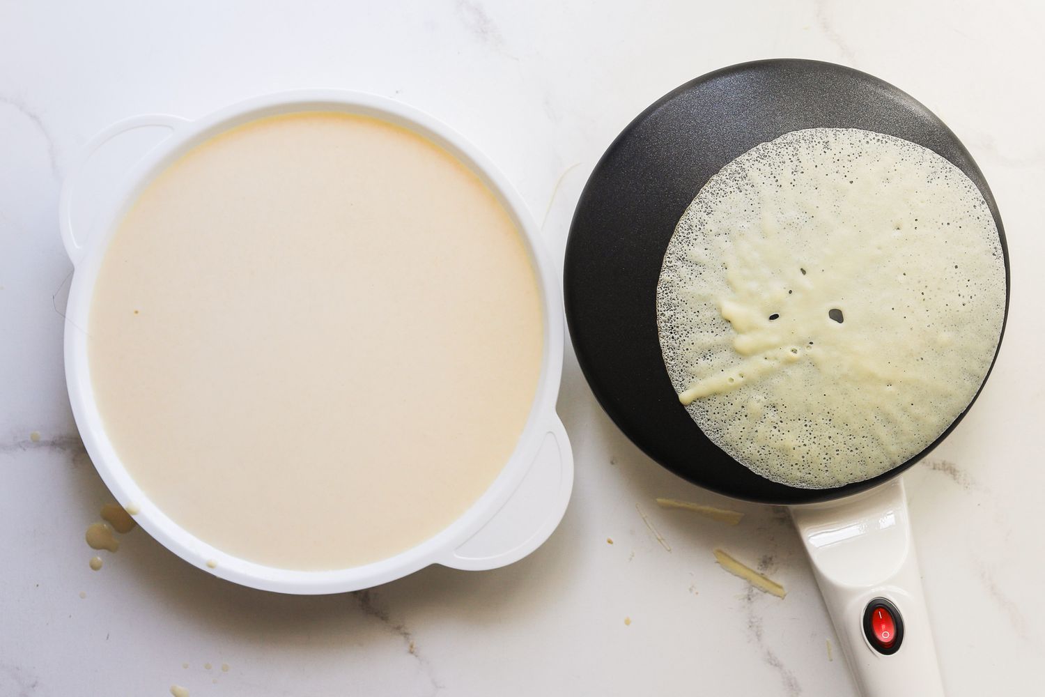 a small crepe cooking on the moss stone electric crepe maker