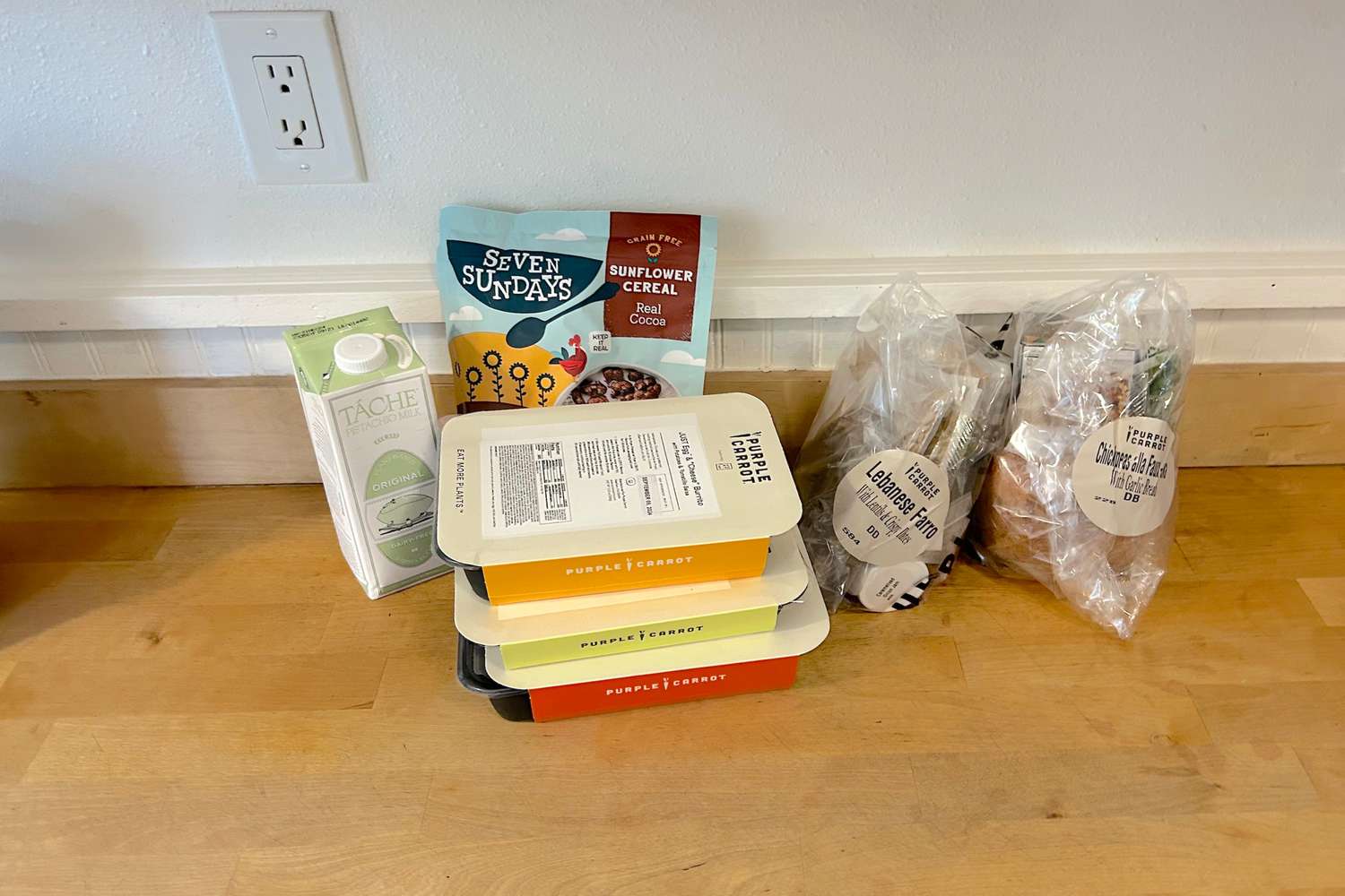 Purple Carrot meal ingredients on a wood surface