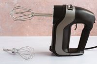 A Hamilton Beach hand mixer on a kitchen countertop.