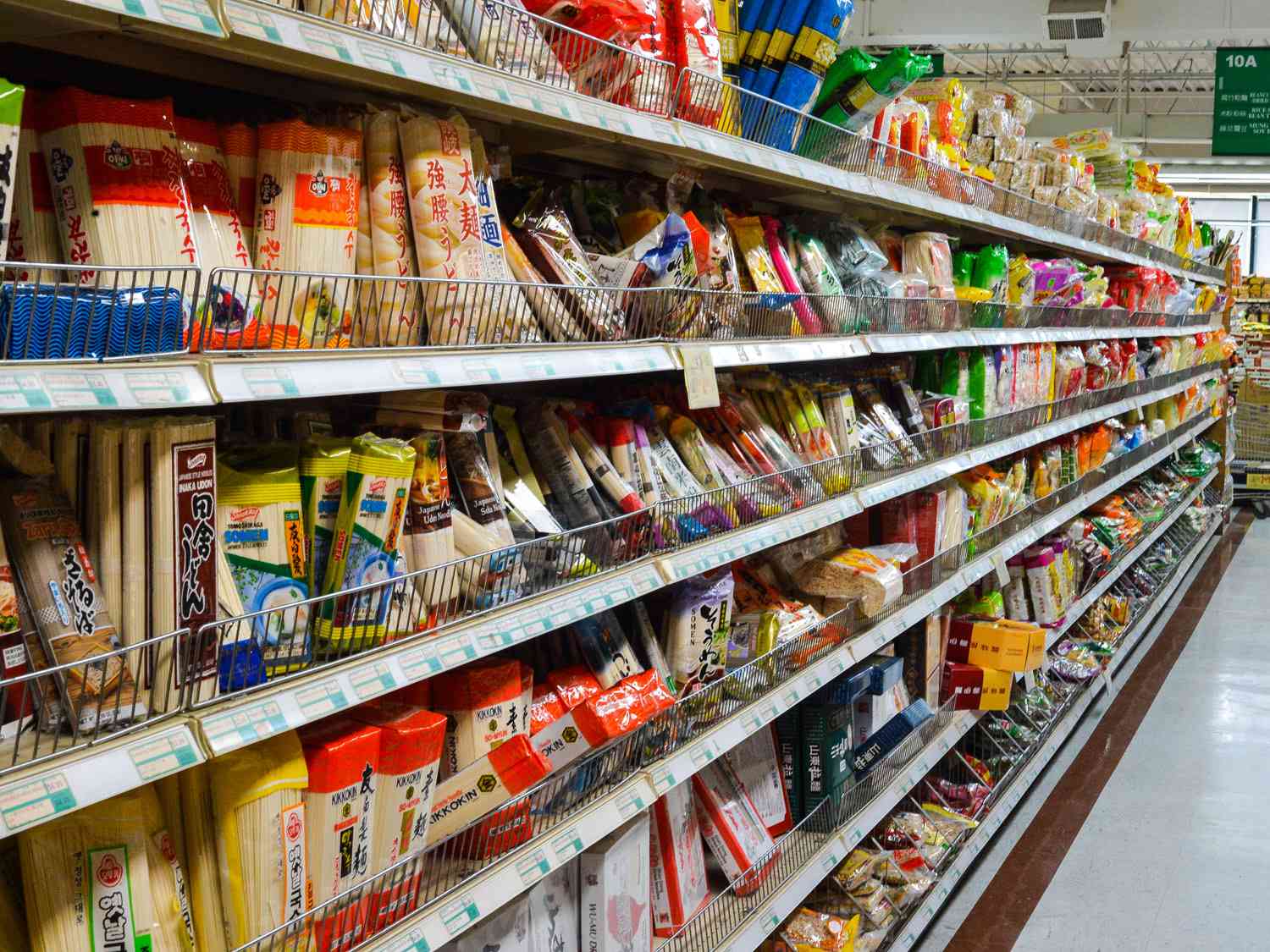 An Asian noodle aisle in a grocery store with dozens of different options.
