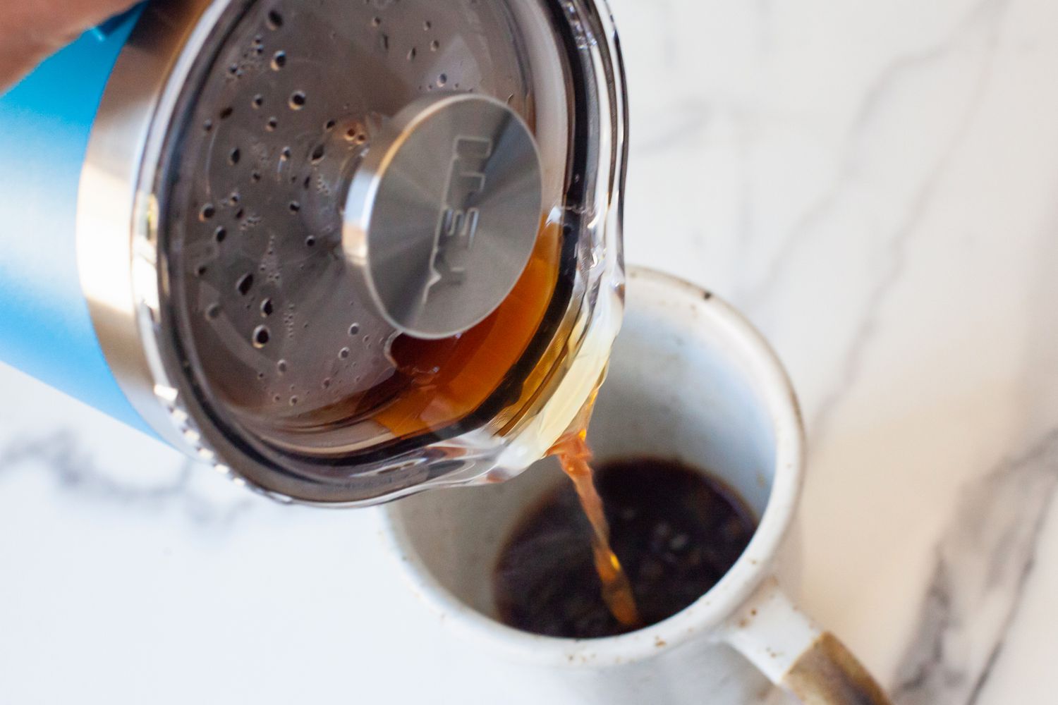 Coffee being poured from the Yeti French Press into a mug