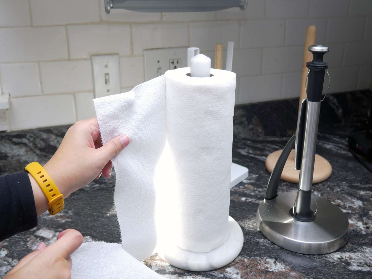 a person tearing off paper towels 