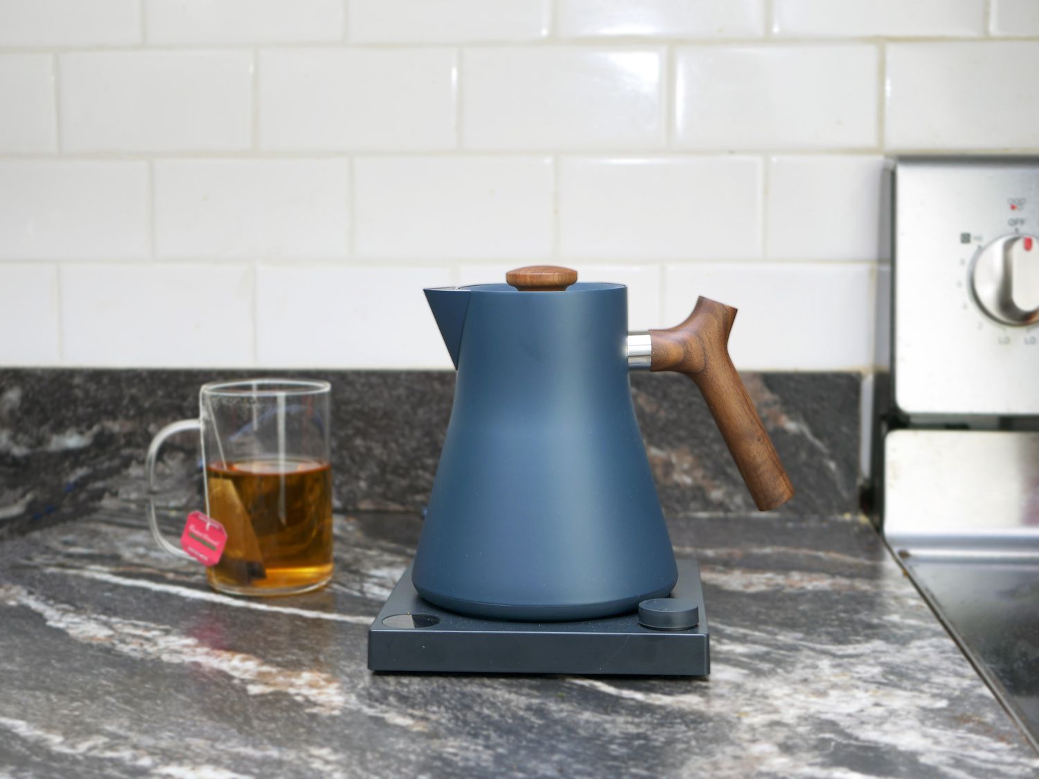 fellow corvo kettle on a countertop with a cup of tea