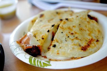 La Super Rica's Quesadilla Pastor on a paper plate.