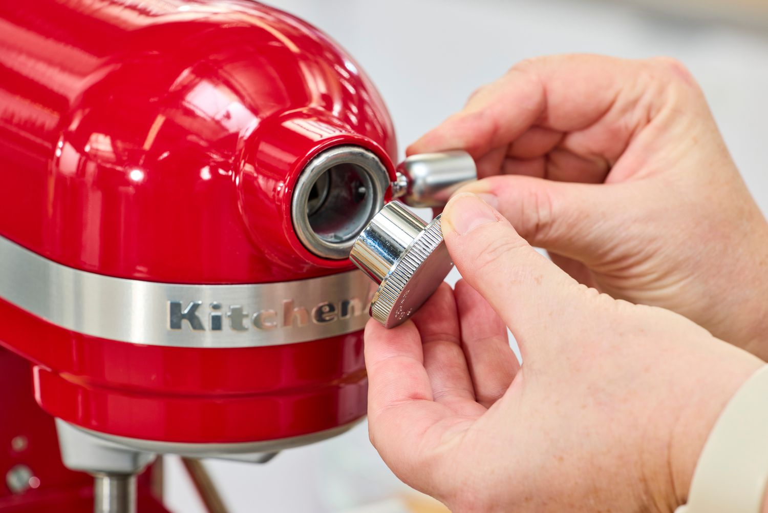 A person adjusts the KitchenAid 7 Quart Bowl Lift Stand Mixer