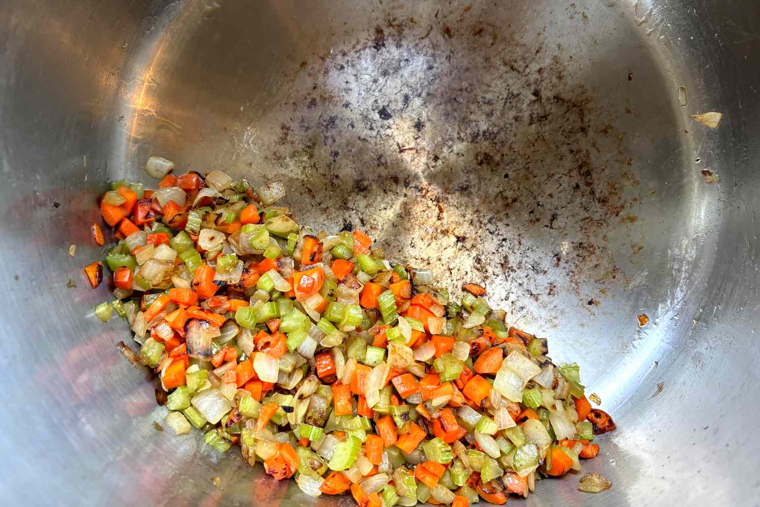 Cooked vegetables in a stainless steel stockpot.