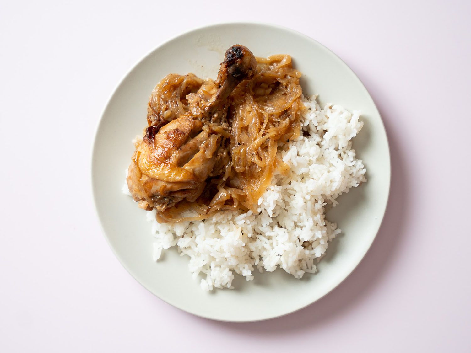 Chicken yassa on a bed of white rice.