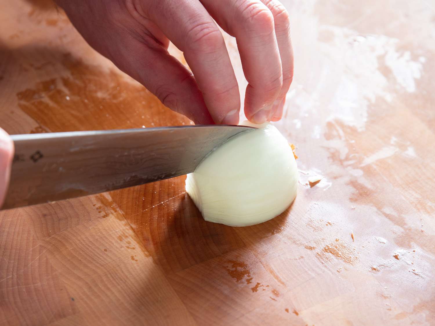 Making second set of vertical cuts along new Y-axis of onion quarter.