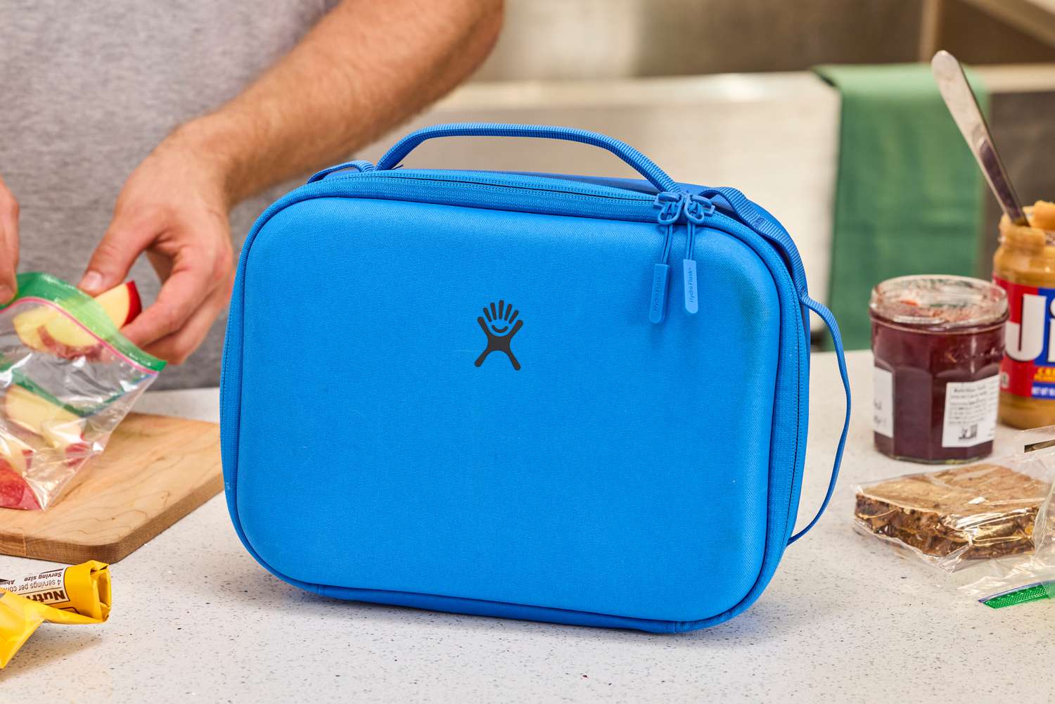 A blue lunch box on a countertop