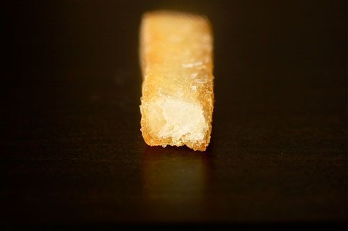 The interior of a McDonald's french fry against a black background