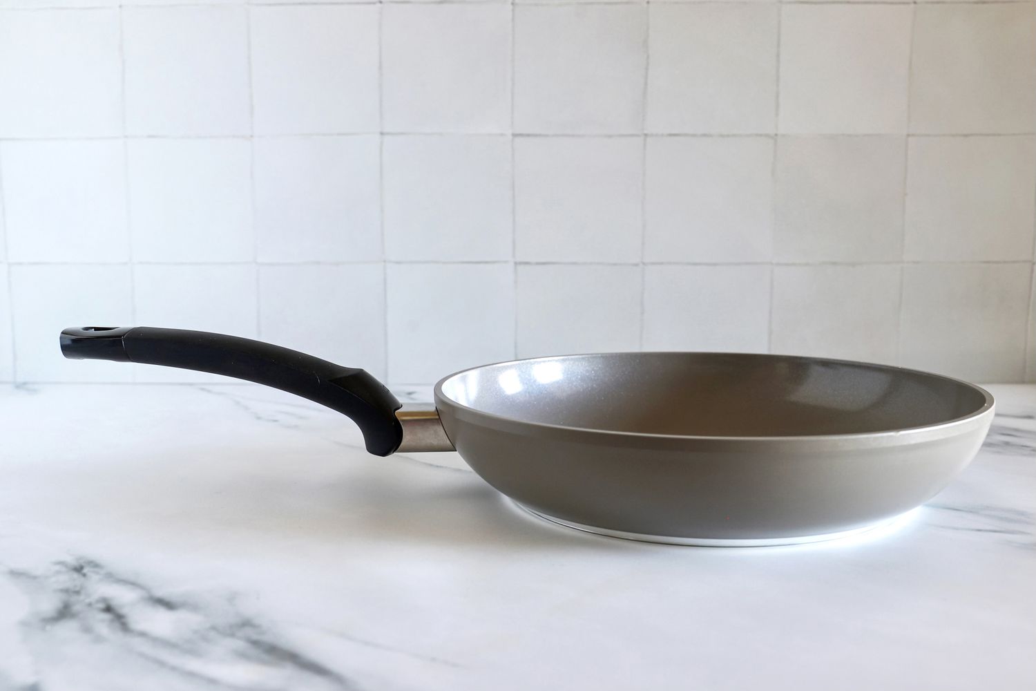 A side view of the Fissler Ceratal Classic 11" Pan set on a countertop