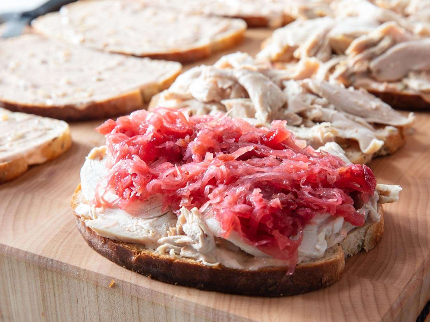 Closeup of cranberry-sauerkraut on top of turkey for a Reuben sandwich.