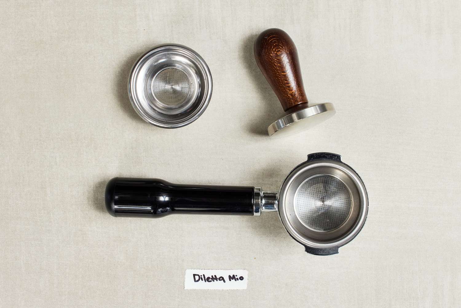 Parts of the portafilter Diletta Mio Espresso Machine on a table