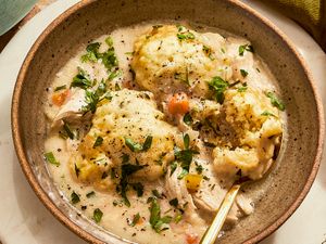Bowl of chicken and dumpling soup with herbs