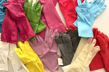 A collection of colorful dish gloves on a counter
