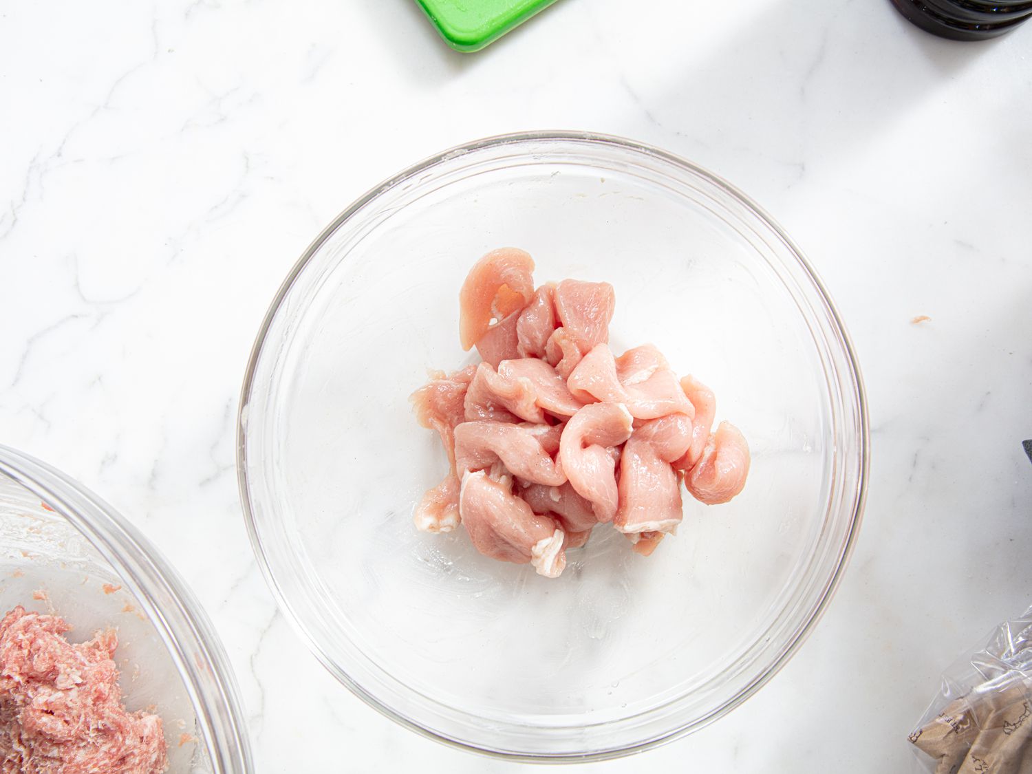 Overhead view of pork marinating in a bowl