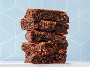 Stacked fudgy brownies with a geometric background
