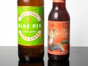 Closeup on the ingredients for a Candy Apple: a bottle of Nine Pin hard cider Bell's Best Brown Ale.