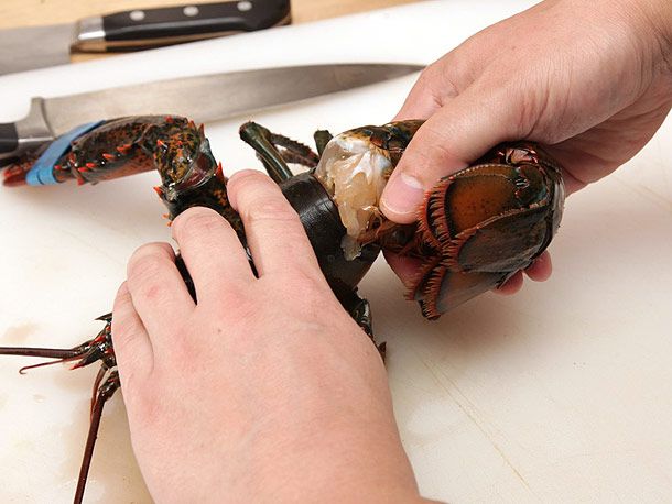 Twisting off the tail of a lobster while holding the carapace in the other hand