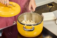 A person removes the lid on the Popsmith The Popper