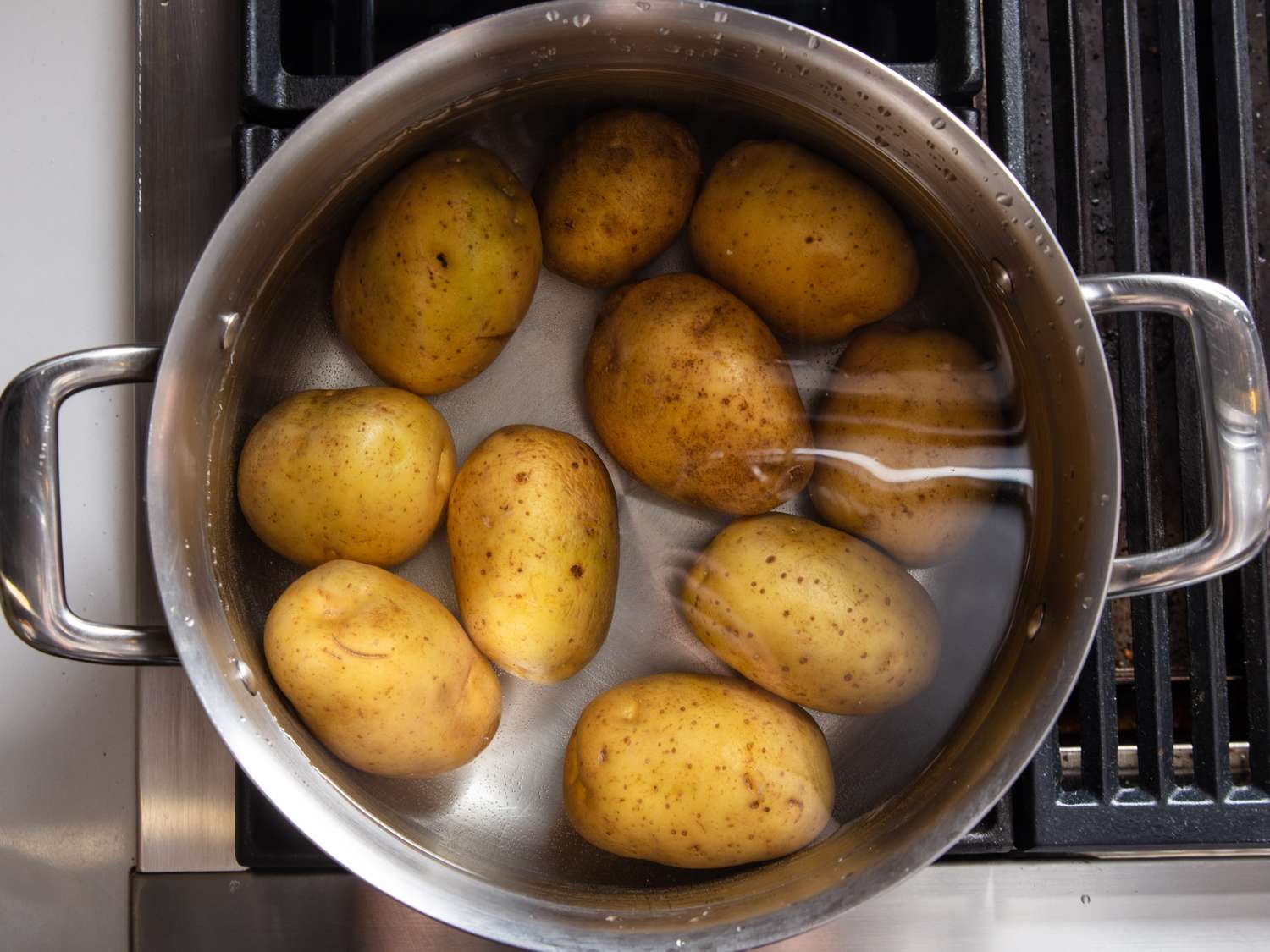 Whole Yukon Gold potatoes in a pot and covered with water.