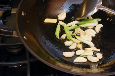 Garlic, Ginger, and Scallions cooking in a wok. 