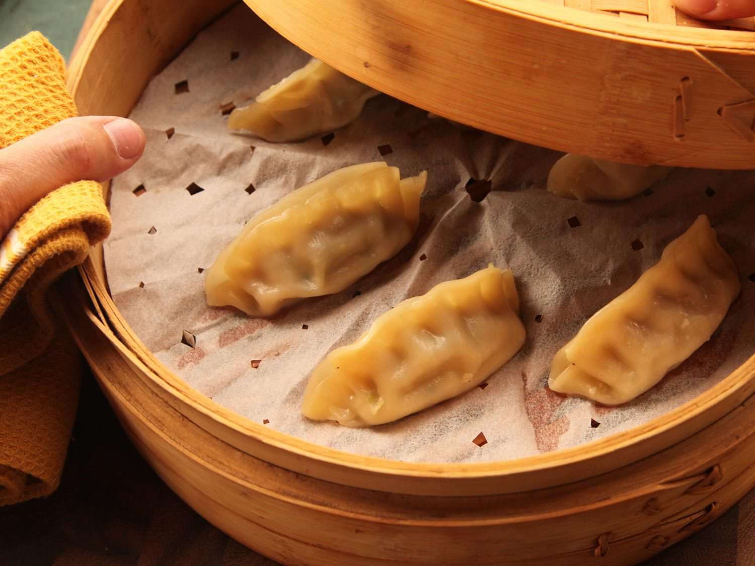 Steaming dumplings in a steamer basket.