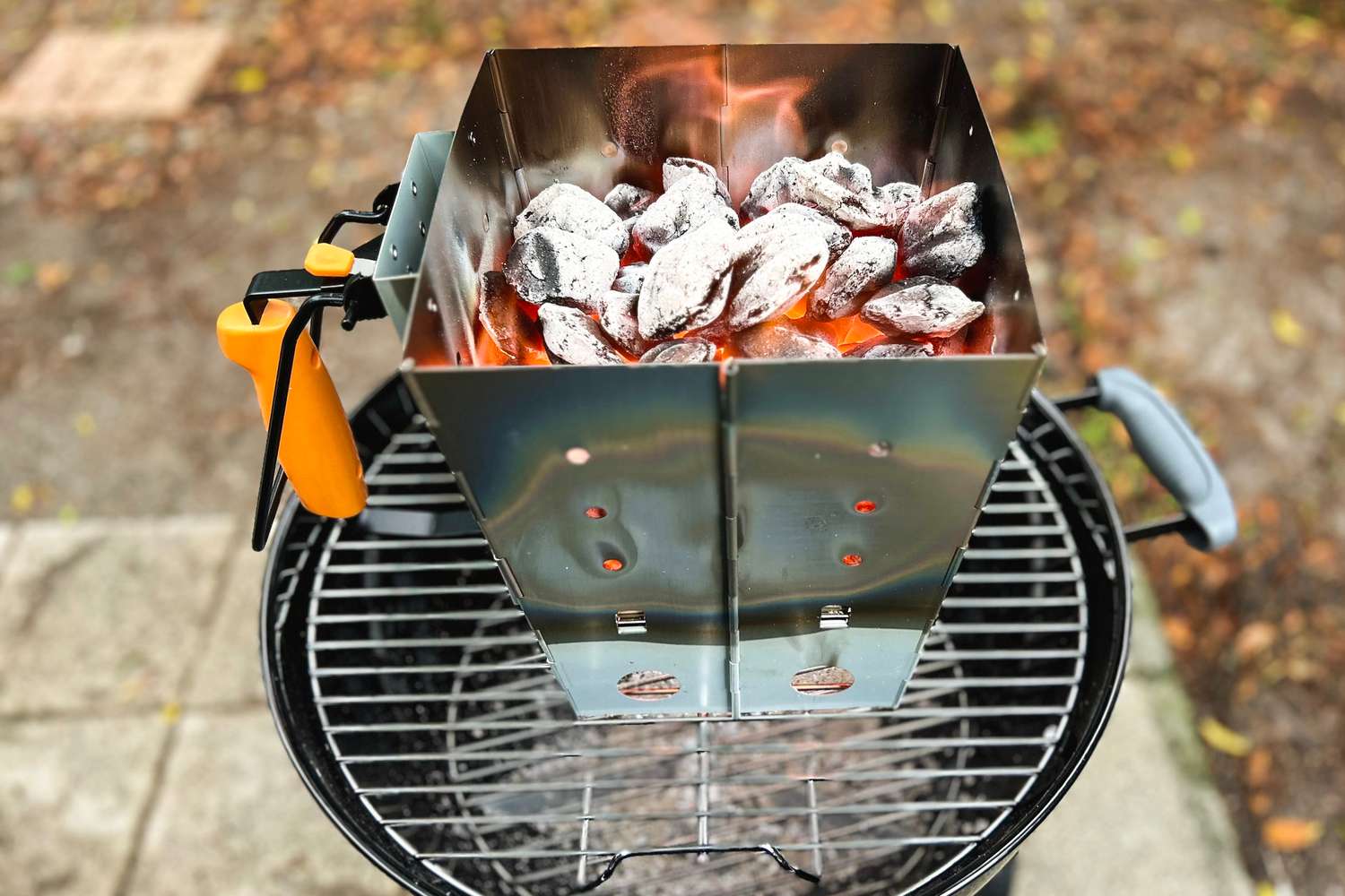 outset charcoal chimney with hot coals in it 