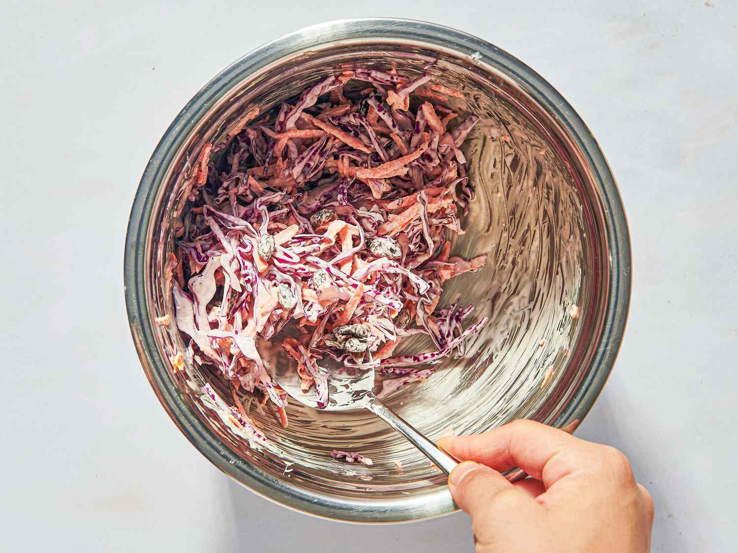 Overhead view of mixing coleslaw