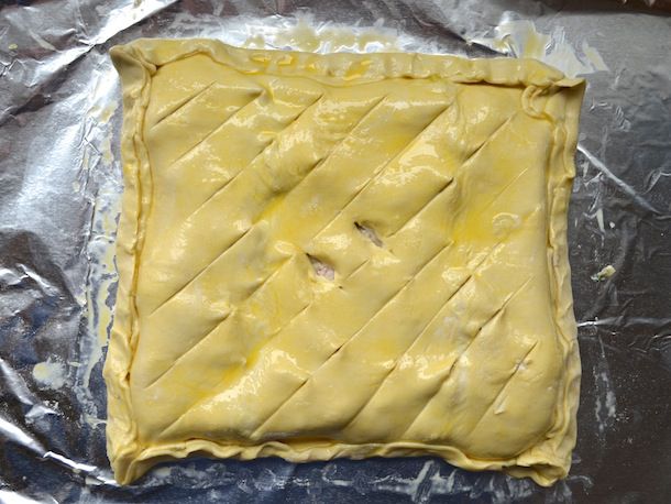 Assembled chicken leek pie, brushed with egg wash.