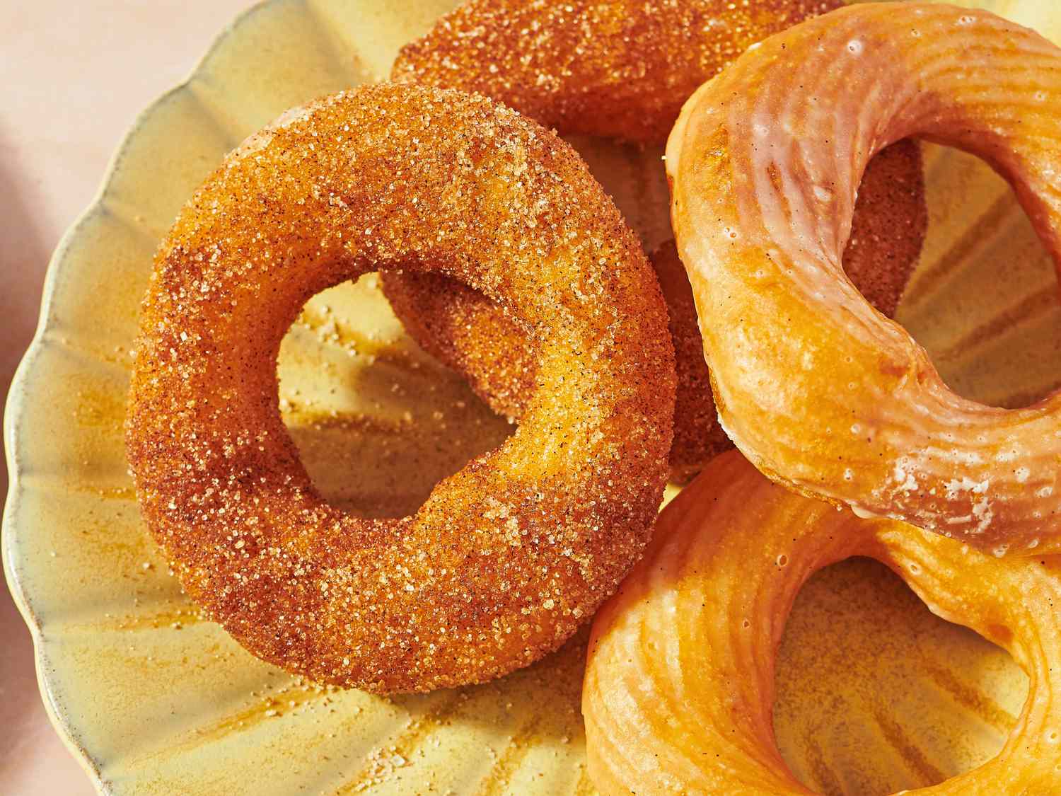 A plate of French crullers and sugared doughnuts