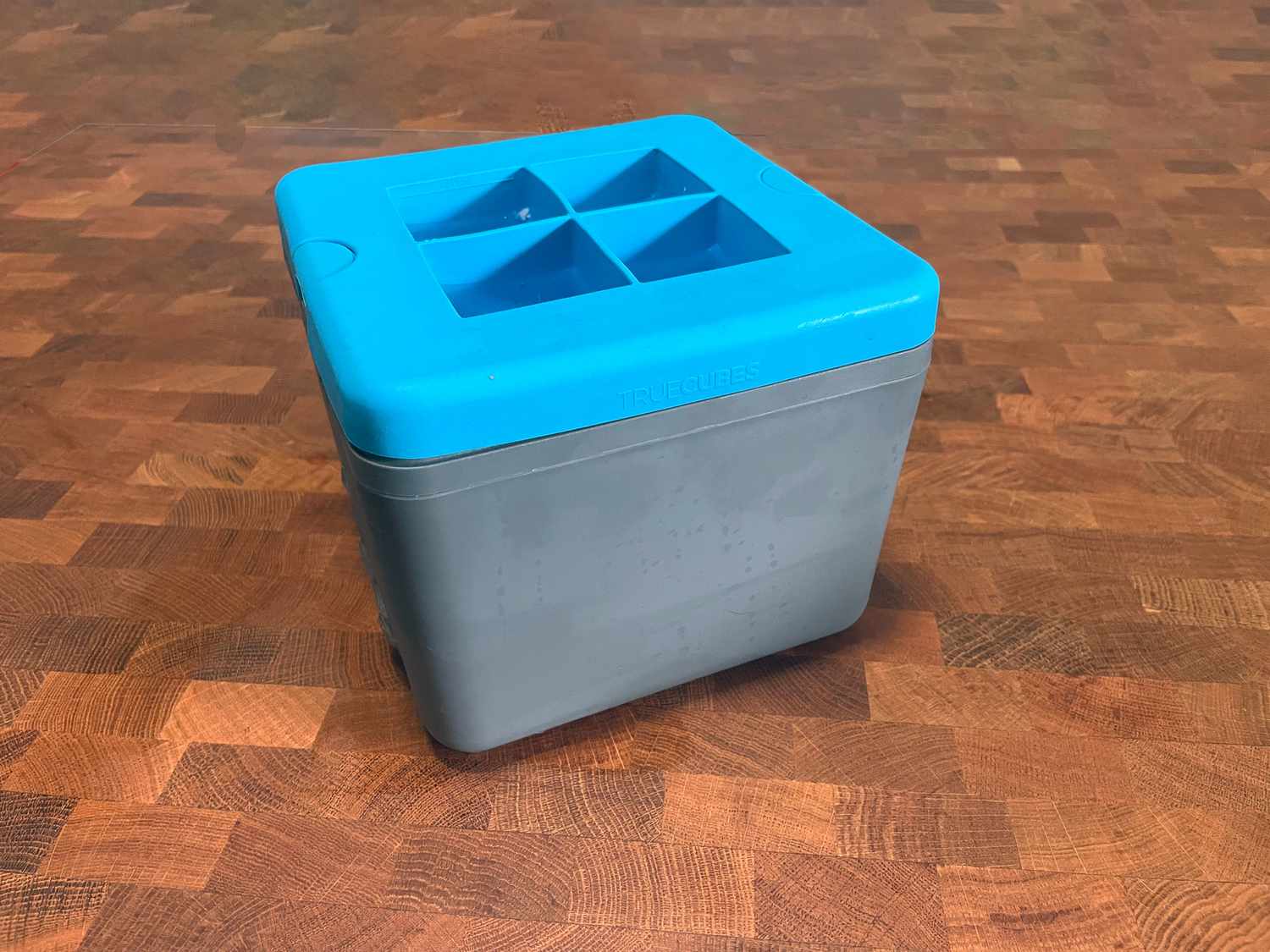 true cubes ice maker on a wooden surface
