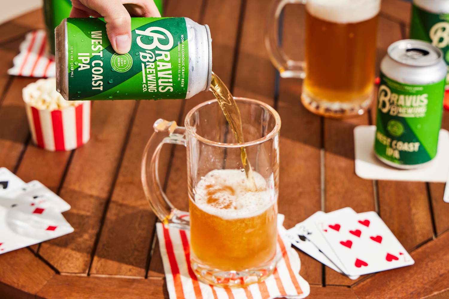 a hand pouring bravus west coast ipa into a glass