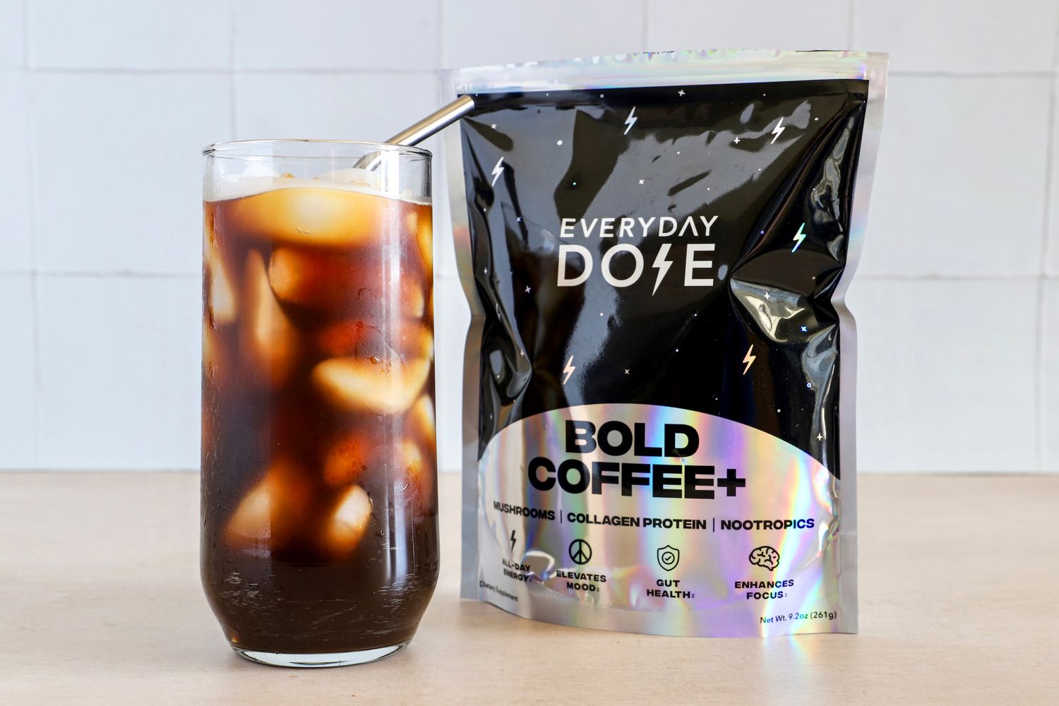 Glass of iced coffee next to a pack of Bold Coffee+ by Everyday Dose