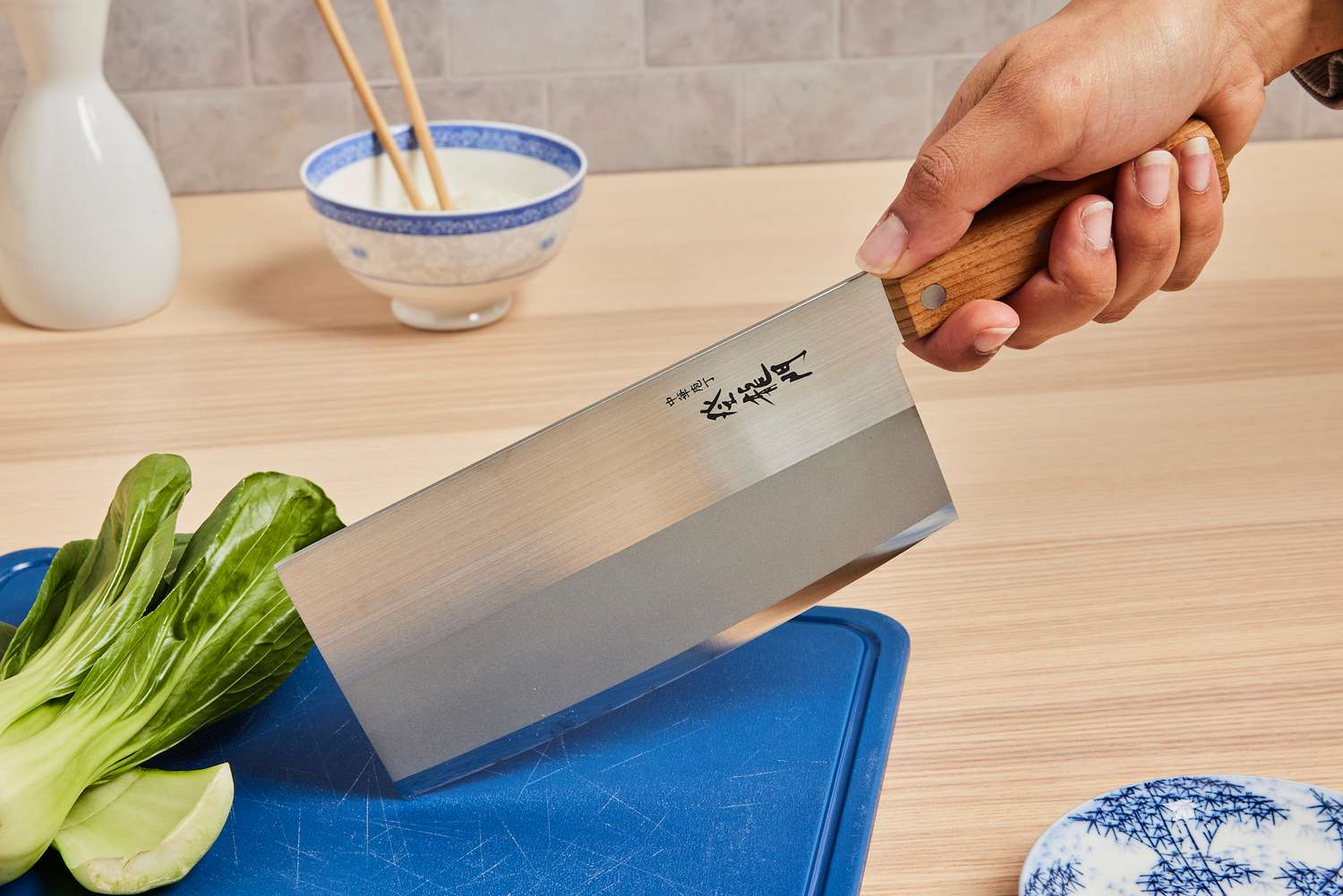 a person holding a Chinese cleaver