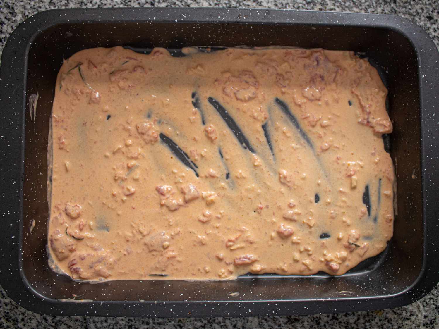 Casserole dish lined with sauce