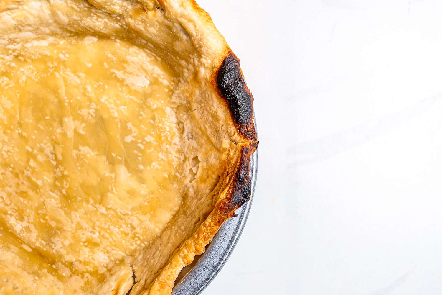 A closeup on a burnt pie crust