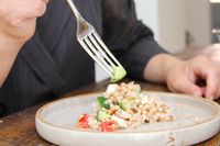 A person using a fork from the Robert Welch Caesna Mirror 5-Piece Flatware Place Setting