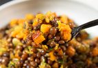 Close up of a spoon of pigeon peas and squash