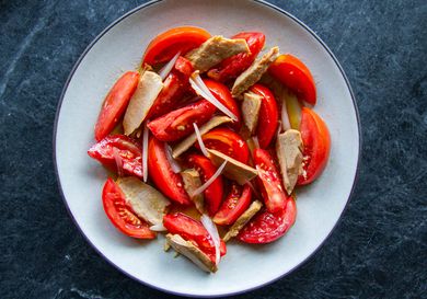 Overhead of a Spanish-style ripe tomato and olive-oil packed tuna salad. 