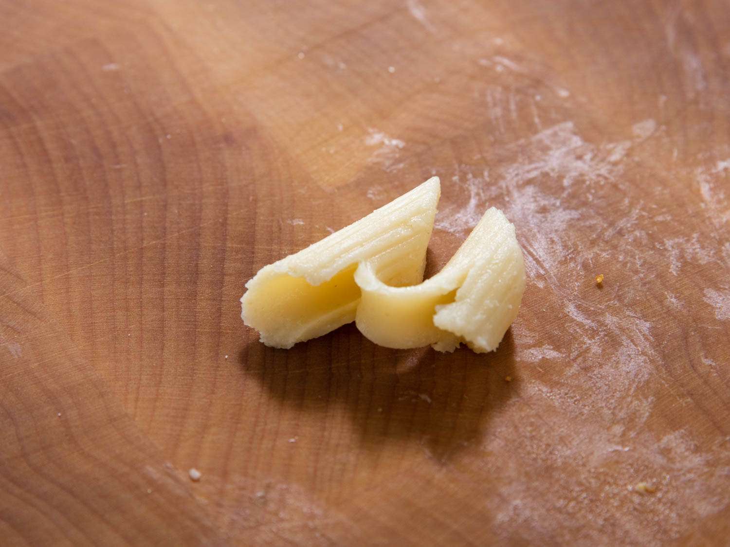 A piece of penne so overcooked, it's cracked in spots