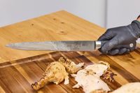 Meat is sliced using the Mercer Culinary 10-Inch Carving Knife