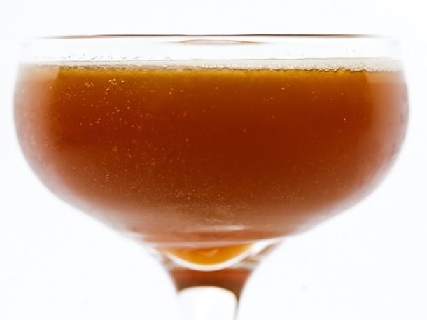 Closeup profile view of a Basin Street Blues cocktail, served in a coupe glass.