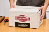 A person holding a box containing a Omaha Steaks Whole Basted Turkey