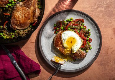 Overhead view of a plate of Costillas a la Riojana with an egg on top