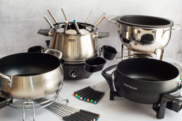 Four fondue posts on a light grey countertop.